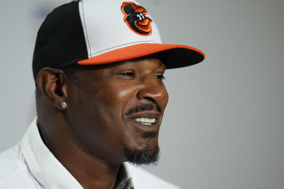Former Baltimore Orioles player Adam Jones speaks during a news conference in which he signed a contract to officially retire prior to a baseball game between the Orioles and the Tampa Bay Rays, Friday, Sept. 15, 2023, in Baltimore. (AP Photo/Julio Cortez)