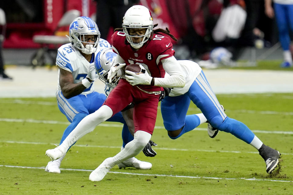 FILE - In this Sunday, Sept. 27, 2020 file photo, Arizona Cardinals wide receiver DeAndre Hopkins (10) is hit by Detroit Lions outside linebacker Christian Jones during the first half of an NFL football game in Glendale, Ariz. Buffalo's Stefon Diggs and Arizona's DeAndre Hopkins are two receivers who have flourished in their new homes after being traded to their respective teams just hours apart in March. The Bills travel to face the Cardinals in a game that's vital for both teams in their chase for the playoffs, Sunday, Nov. 15, 2020. (AP Photo/Ross D. Franklin, File)