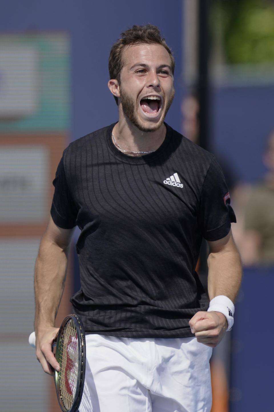 Hugo Gaston, of France, reacts after defeating John Isner, of the United States, during the Miami Open tennis tournament, Friday, March 25, 2022, in Miami Gardens, Fla. (AP Photo/Marta Lavandier)