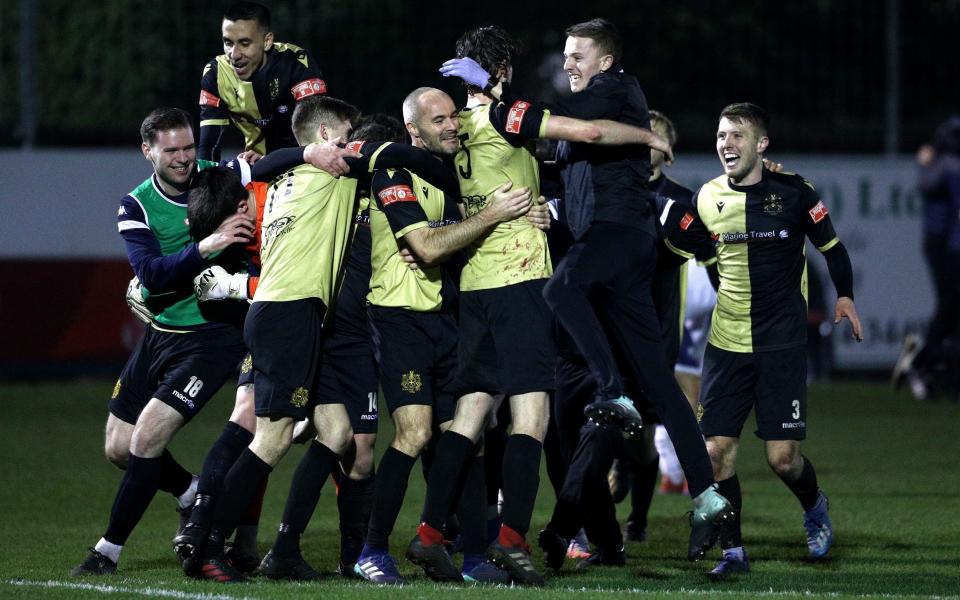 Marine FC players celebrate winning the match after the final whistle during the Emirates FA Cup Second Round match between Marine FC and Havant and Waterloovile a - Getty Images