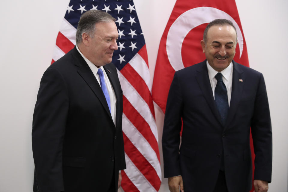 U.S. Secretary of State Mike Pompeo, left, shakes hands with Turkey's Foreign Minister Mevlut Cavusoglu before their meeting during a NATO Foreign Ministers meeting at the NATO headquarters in Brussels, Wednesday, Nov. 20, 2019. (AP Photo/Francisco Seco, Pool)