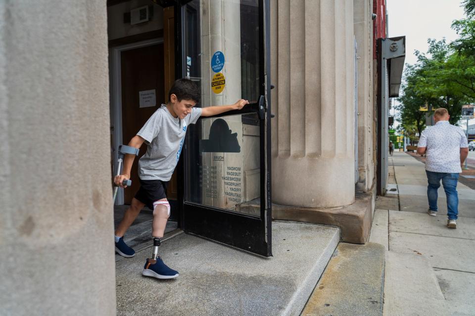 Saleh Humaid, 8, of Gaza, walks out of Anew Life Prosthetics and Orthotics in Detroit for the first time on Thursday, July, 27. 2023, after receiving his prosthetic leg while in the United States. Humaid's leg was bombarded with the shrapnel from an exploding car he and his dad happened to be passing in the road as it was targeted for a drone strike. The damage to his nerves was too severe to repair and surgeons in the Gaza Strip could not save his limb.