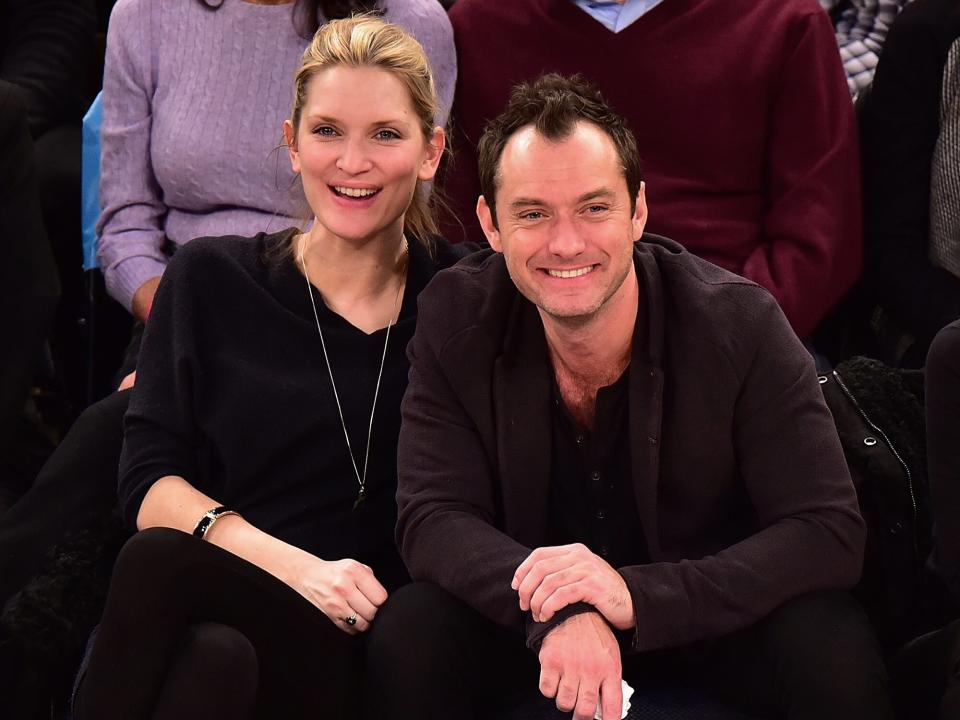 Phillipa Coan and Jude Law attend the Orlando Magic vs New York Knicks game at Madison Square Garden on February 26, 2016 in New York City