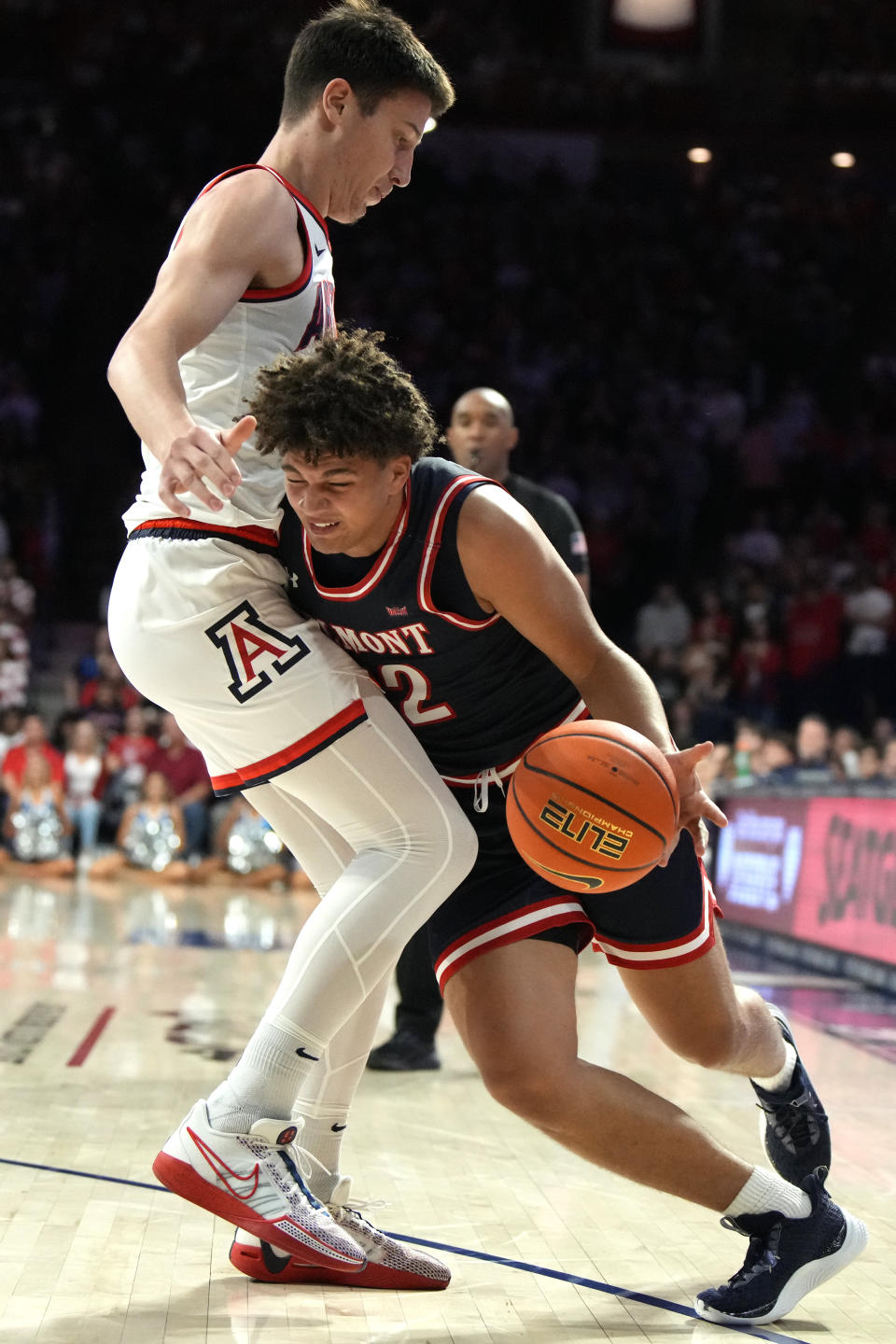 Belmont guard Kyler Vanderjagt (22) drives on Arizona forward Filip Borovicanin during the first half of an NCAA college basketball game Friday, Nov. 17, 2023, in Tucson, Ariz. (AP Photo/Rick Scuteri)