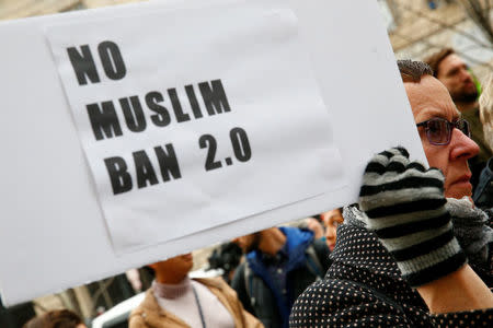 Immigration activists, including members of the DC Justice for Muslims Coalition, rally against the Trump administration's new ban against travelers from six Muslim-majority nations, outside of the U.S. Customs and Border Protection headquarters in Washington, U.S., March 7, 2017. REUTERS/Eric Thayer