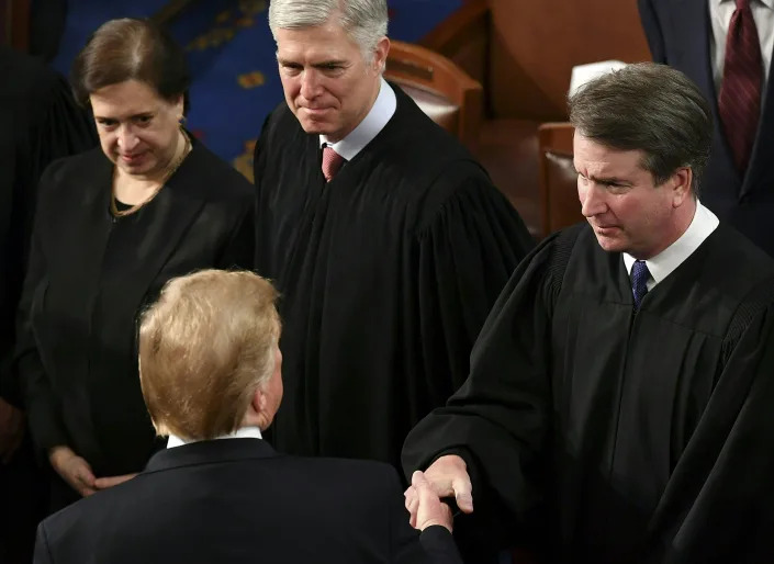 US President Donald Trump greets US Supreme Court Justice Brett Kavanaugh (R) following his State of the Union address at the US Capitol in Washington, DC, on February 5, 2019.