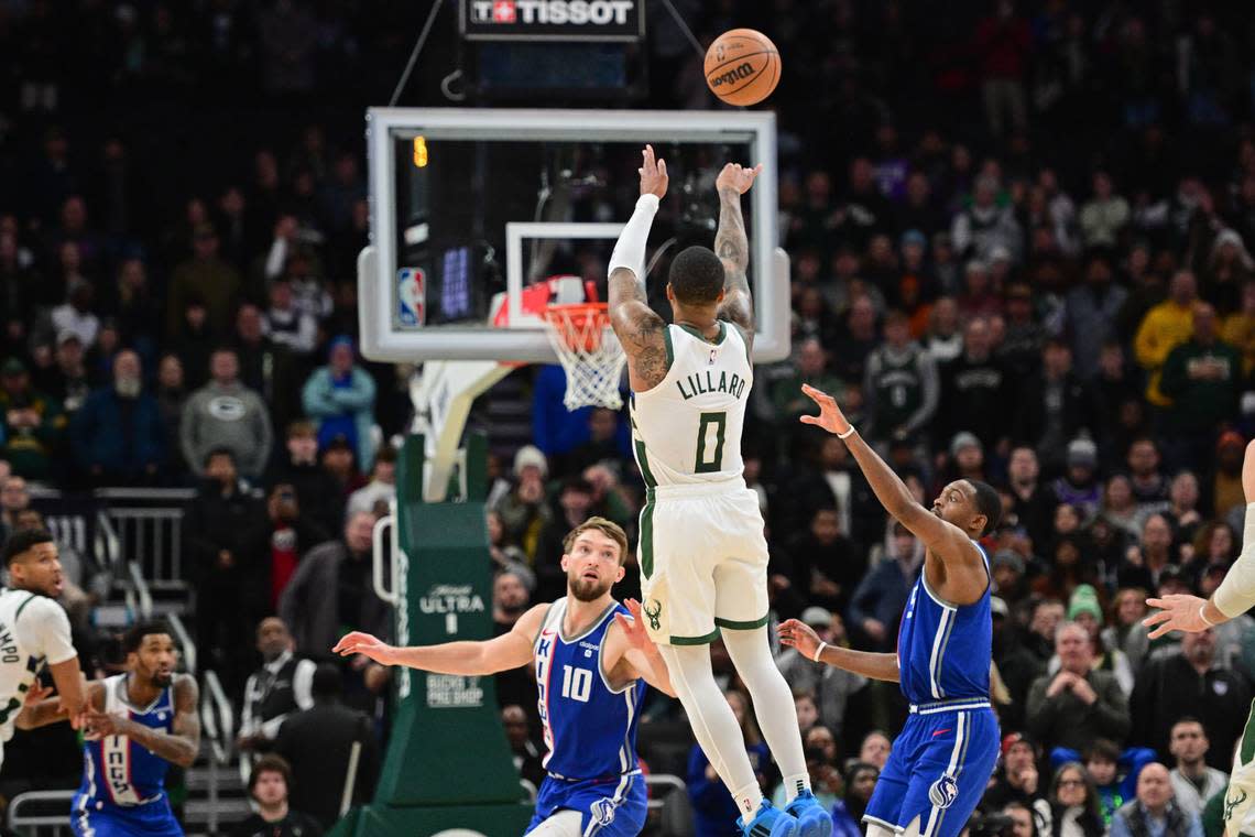 Milwaukee Bucks guard Damian Lillard (0) scores the game-winning 3-point basket at the end of overtime against the Sacramento Kings on Sunday. Benny Sieu/USA TODAY Sports