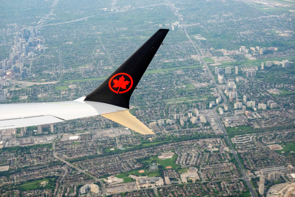 FILE PHOTO: An Air Canada plane is seen in the air after departing from Pearson International Airport in Toronto, Ontario, Canada May 16, 2022.  REUTERS/Carlos Osorio/File Photo