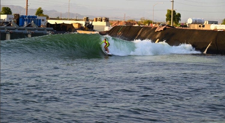 A surfer test rides the first half of the surfing lagoon at Cannon Beach. The second half will soon begin construction.