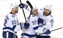 Tampa Bay Lightning center Yanni Gourde (37) is congratulated on his goal by defenseman Kevin Shattenkirk (22) and center Blake Coleman (20) after scoring against the Columbus Blue Jackets during the second period of NHL Eastern Conference Stanley Cup first round playoff hockey action in Toronto, Monday, Aug. 17, 2020. (Frank Gunn/The Canadian Press via AP)