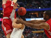 <p>Villanova guard Josh Hart (3) drives to the basket against Wisconsin forward Ethan Happ (22) and forward Vitto Brown (30) with three seconds remaining in the second half of a second-round men’s college basketball game in the NCAA Tournament, Saturday, March 18, 2017, in Buffalo, N.Y. A Villanova foul was called on the play and Wisconsin won, 65-62. (AP Photo/Bill Wippert) </p>