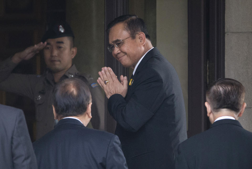 CORRECTS TYPO - Thailand's Prime Minister Prayuth Chan-ocha, center, arrives at government house in Bangkok, Thailand, Thursday, June 6, 2019. Thailand's Parliament elected 2014 coup leader Prayuth Chan-ocha as prime minister in a vote Wednesday that helps ensure the military's sustained dominance of politics since the country became a constitutional monarchy nearly nine decades ago. (AP Photo/Sakchai Lalit)