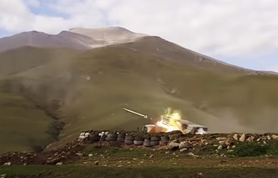 In this handout photo taken from video released by Azerbaijan's Defense Ministry on Saturday, Oct. 3, 2020, an Azerbaijan's army's multiple rocket launcher fires during fighting with forces of the self-proclaimed Republic of Nagorno-Karabakh, Azerbaijan. Armenia and Azerbaijan on Saturday said heavy fighting is continuing in their conflict over the separatist territory of Nagorno-Karabakh. Azerbaijan's president criticized the international mediators who have tried for decades to resolve the dispute. Fighting that started Sept. 27 is the worst to afflict Nagorno-Karabakh and surrounding areas since the 1994 end of a war that left the region in Azerbaijan under the control of ethnic Armenian local forces backed by Armenia. (Azerbaijan's Defense Ministry via AP)
