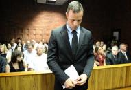 South African Olympic sprinter Oscar Pistorius appears on February 20, 2013 at the Magistrate Court in Pretoria. Witnesses claimed they heard arguing, a woman screaming and gunfire at the house of "Blade Runner" Oscar Pistorius the night he shot dead his model girlfriend, police told a South African court Wednesday