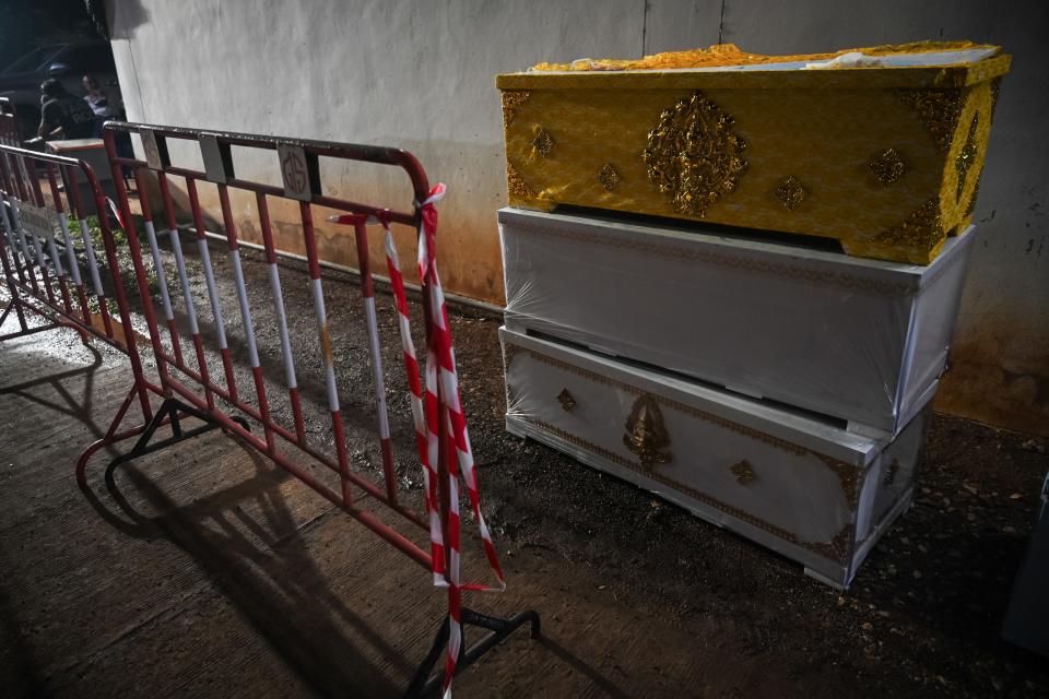 Coffins are seen outside a child care center on Thursday, Oct. 6, 2022 in Nong Bua Lamphu, Thailand.