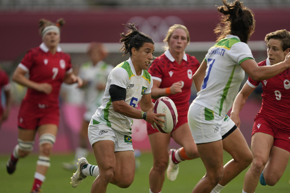 Brazil's Isadora Cerullo runs with the ball in Brazil's women's rugby sevens 9-12 placing match against Canada at the 2020 Summer Olympics, Friday, July 30, 2021 in Tokyo, Japan. (AP Photo/Shuji Kajiyama)