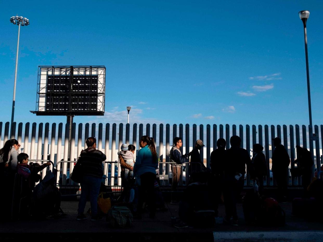 Asylum seekers wait for their turn to cross from Mexico into the United States in Tijuana, on 29 February 2020: AFP