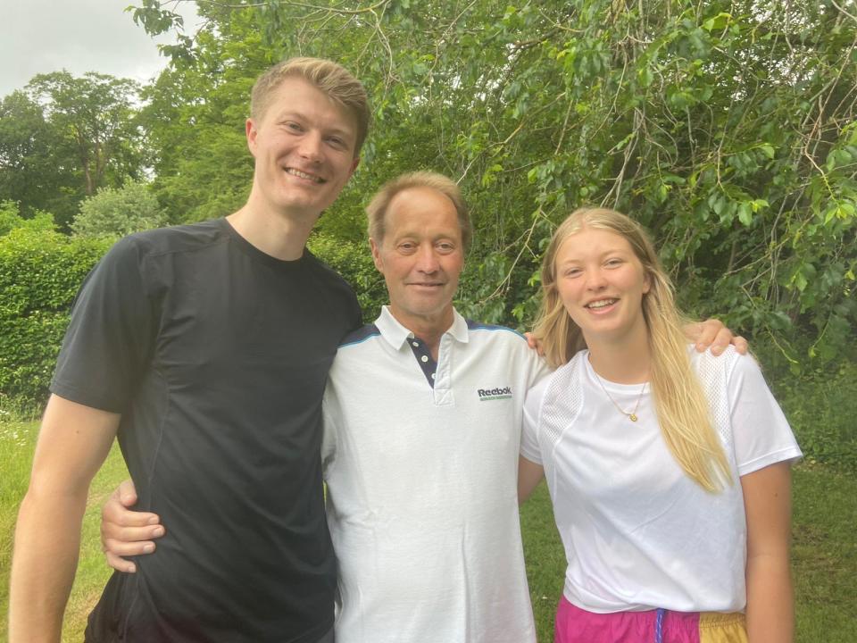 Three people standing next to each other and looking at the camera