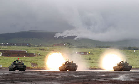 FILE PHOTO: Japanese tanks fire during an annual training session near Mount Fuji west of Tokyo, August 23, 2018. REUTERS/Kim Kyung-Hoon/File Photo
