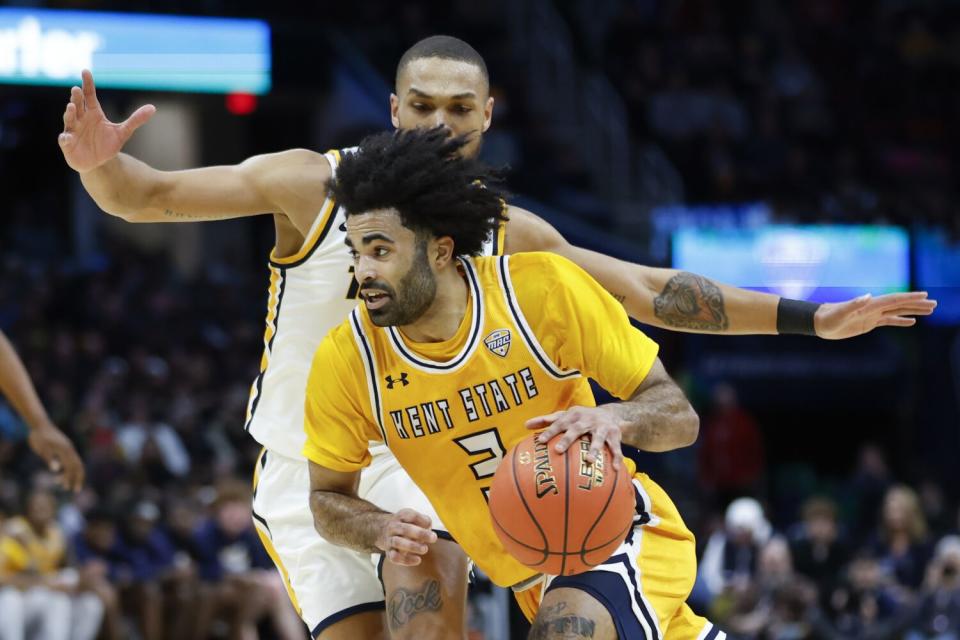 Kent State guard Sincere Carry drives against Toledo forward Setric Millner Jr.