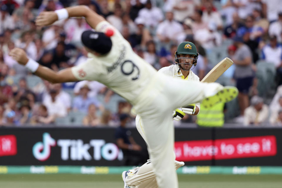 Australia's Mitchell Starc, right, hits a ball past England's James Anderson during the second day of their Ashes cricket test match in Adelaide, Australia, Friday, Dec. 17, 2021. (AP Photo/James Elsby)