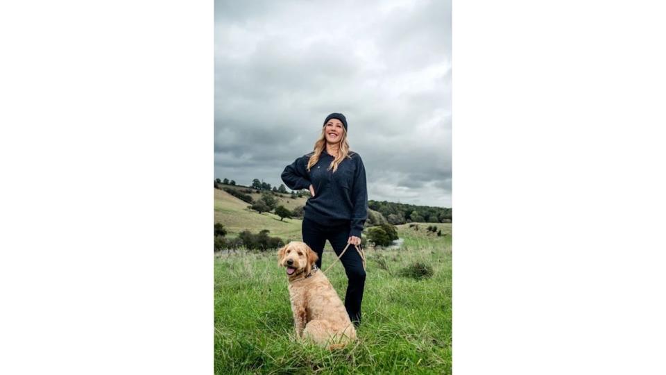 Ellie Goulding in a field with a dog