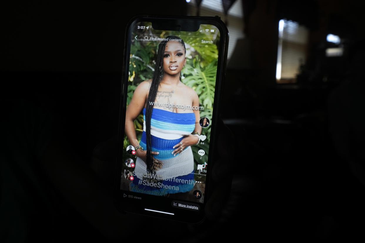 Sheena Scarbrough shows a picture of her daughter Sade Carleena Robinson Tuesday, April, 9, 2024, in Milwaukee. Robinson was in Jamaica in this photo on a trip she took this year. She loves taking solo trips. She went to New Orleans, Atlanta and many other places. Ebony Cox / Milwaukee Journal Sentinel