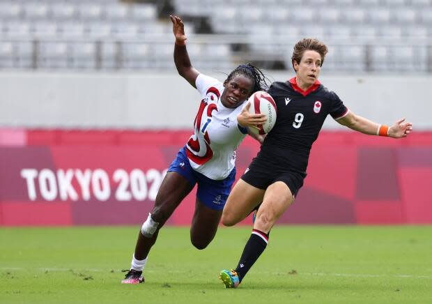 Canadian rugby sevens captain Ghislaine Landry, right, evades France's Séraphine Okemba during Canada's 31-0 loss in Tokyo on Friday. (Siphiwe Sibeko/Reuters - image credit)