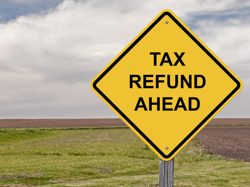 Road sign saying tax refund ahead