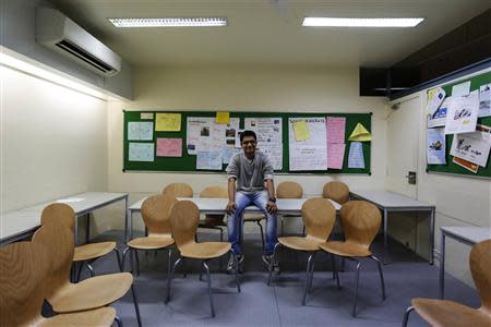 Anuj Trivedi, a 19-year-old student, poses inside his classroom at an institute in Mumbai March 19, 2014. REUTERS/Danish Siddiqui