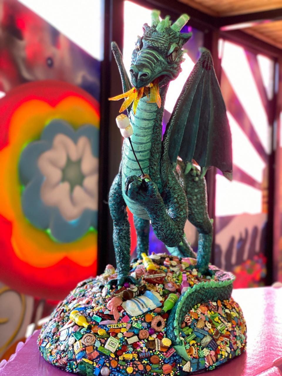 Enid artist Lori Hill crafted a candy-hoarding dragon named "Sugaryen" out of polymer clay on a wire armature. The sculpture is included in the immersive art experience "Sugar High," open in Enid through May 8.
