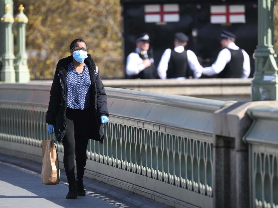 A woman walks across Westminster Bridge in London as the UK continues in lockdown to help curb the spread of the coronavirus: Kirsty O'Connor/PA