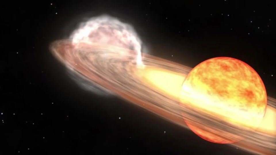 A red giant star and a white dwarf orbit each other in this animation of a nova that looks like T Coronae Borealis.  The red giant is a large sphere in red, orange, and white, with the side facing the white dwarf in the lighter colors.  The white dwarf is hidden in a bright glow of white and yellow, indicating an accretion disk around the star.  A stream of material, shown as a red diffuse cloud, flows from the red giant to the white dwarf.  / Credit: NASA/Goddard Space Flight Center