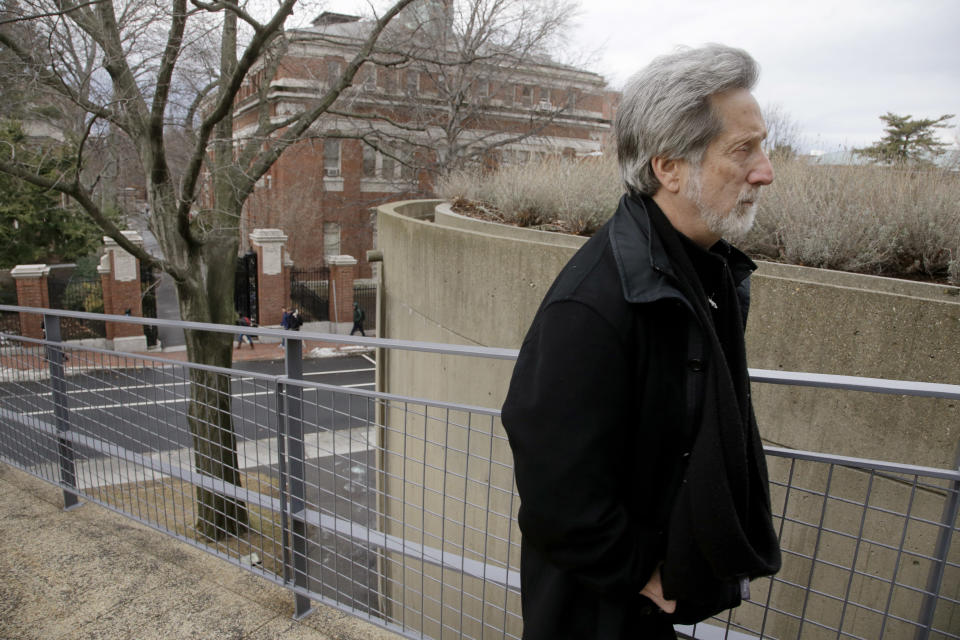 In this Monday, Jan. 27, 2014 photo, film professor Robb Moss, who has taught for twenty-five years at Harvard, walks outside the Carpenter Center for the Visual Arts on the school's campus in Cambridge, Mass, Mass. Three filmmakers nominated separately for this year’s Oscar for best feature documentary credit Moss for inspiring them to greatness. (AP Photo/Stephan Savoia)