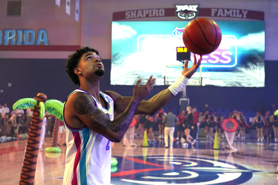 FAU guard Nick Boyd warms up before a skills challenge during a Paradise Madness ceremony for the NCAA college basketball team Wednesday, Oct. 25, 2023, in Boca Raton, Fla. (AP Photo/Lynne Sladky)