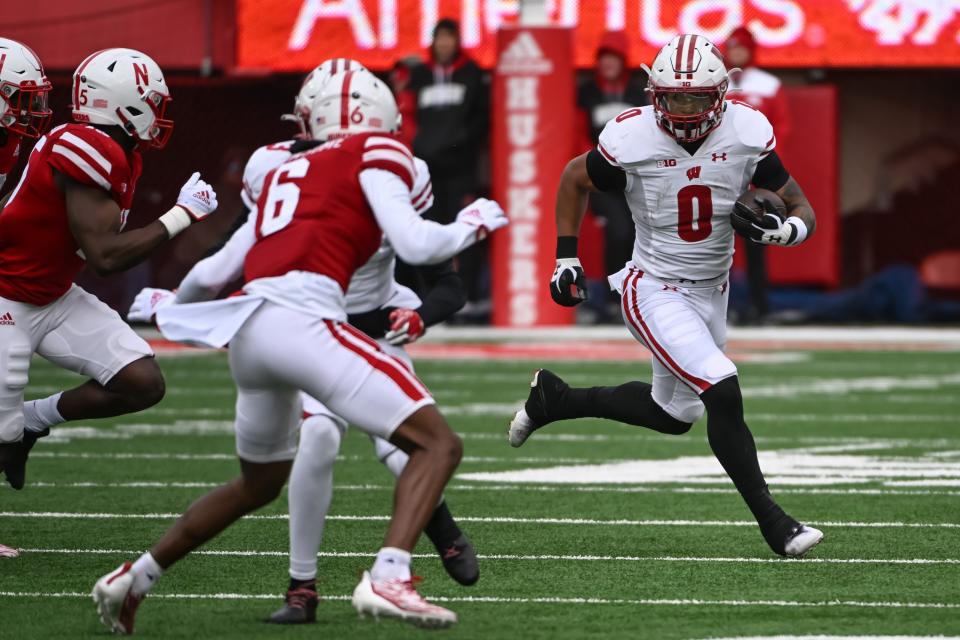 Wisconsin running back Braelon Allen (0) runs against Nebraska defensive back Quinton Newsome (6) during the second quarter on Saturday, Nov. 19, 2022, at Memorial Stadium in Lincoln, Nebraska.