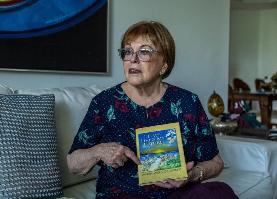 Evelyn Walg Grunberg displays a book she wrote about her family history and their escape from Nazism during the Holocaust in 1942. Pedro Portal/pportal@miamiherald.com