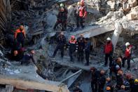 Rescue workers search the site of a collapsed building, after an earthquake in Elazig