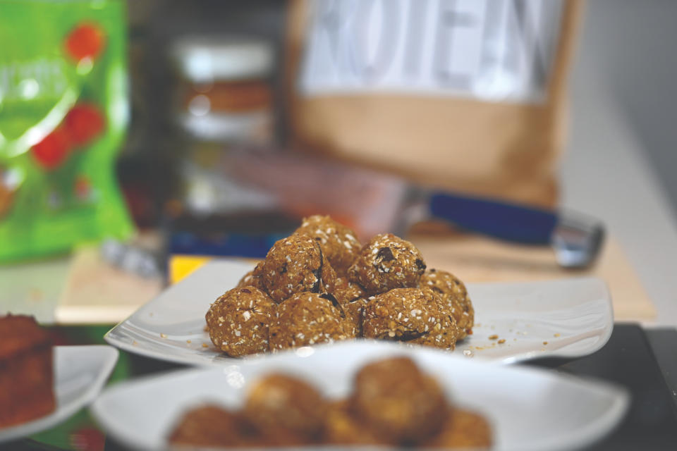 Homemade chocolate peanut balls stacked on a plate