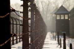 <span class="caption">The poet Janina Degutytė wrote a poem about Lithuanian victims after visiting Auschwitz in Poland.</span> <span class="attribution"><a class="link " href="https://www.shutterstock.com/image-photo/auschwitz-poland-february-10-2019-museum-585719252" rel="nofollow noopener" target="_blank" data-ylk="slk:Szymon Kaczmarczyk/Shutterstock;elm:context_link;itc:0;sec:content-canvas">Szymon Kaczmarczyk/Shutterstock</a></span>