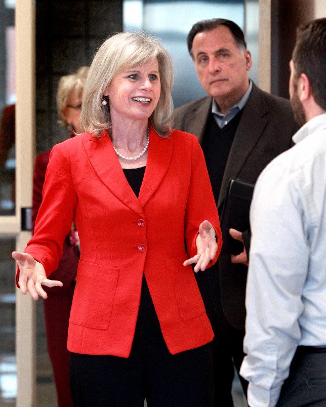 In this Wednesday, April 16, 2014 photo Wisconsin gubernatorial candidate Mary Burke speaks with Scott Ziolkowski, an instructor in the Physical Therapy Assistant program at Western Technical College, as she campaigns in La Crosse, Wis. Wisconsin Democrats and their allies who are trying to take out Republican Gov. Scott Walker have invested all their hopes in Burke, a Harvard-educated political newcomer whose father started Trek Bicycle when she was a teenager. (AP Photo/The La Crosse Tribune, Peter Thomson)