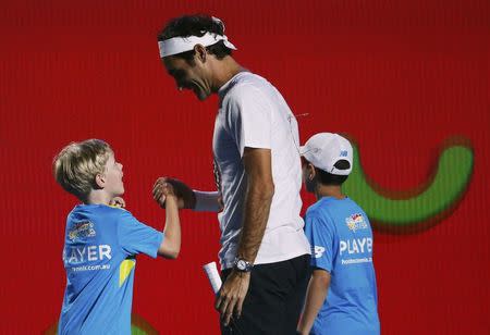 Switzerland's Roger Federer reacts with children during a promotional event ahead of the Australian Open tennis tournament in Melbourne, Australia, January 14, 2017. REUTERS/Edgar Su