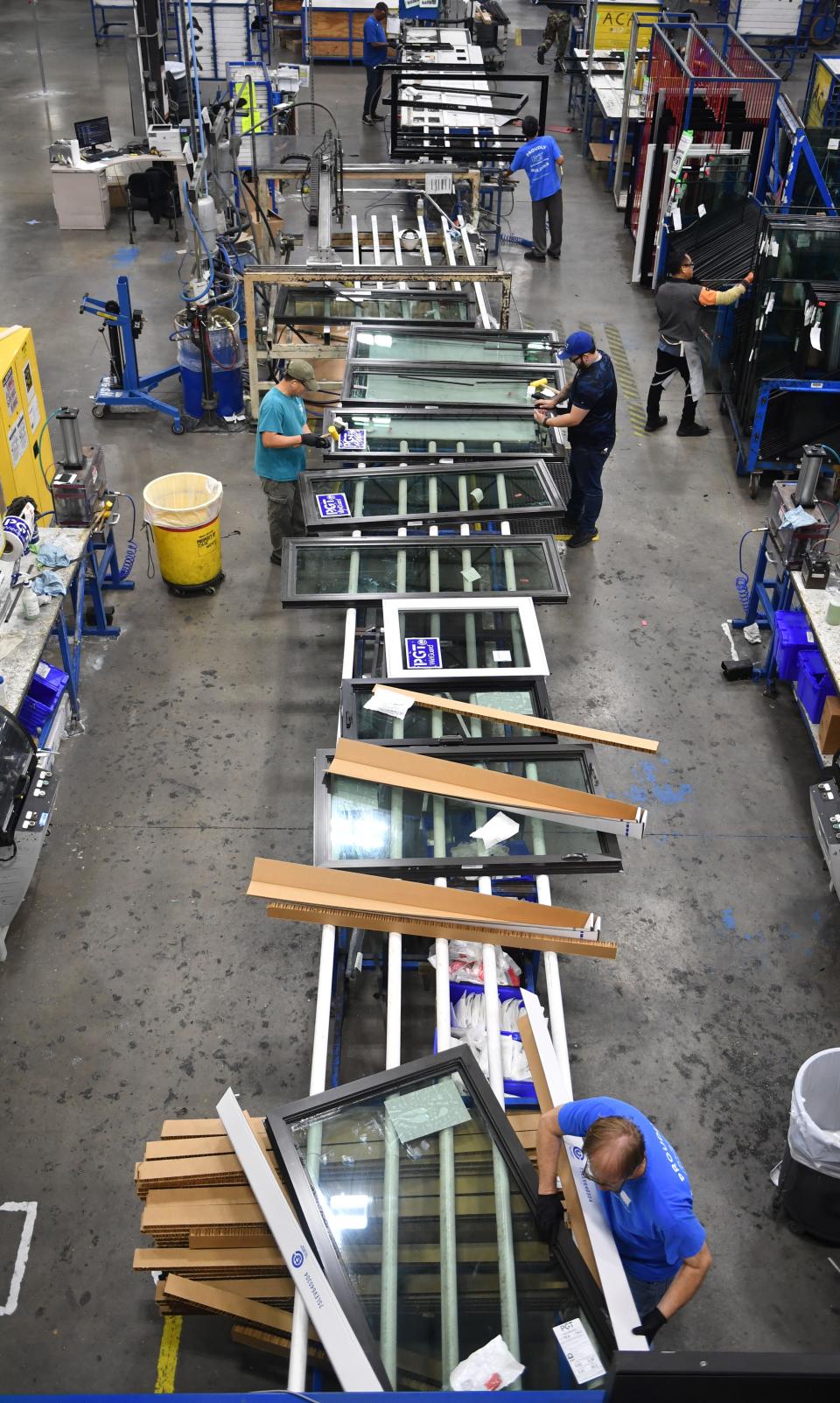 PGT employees prepare completed windows for shipping on the production floor of the PGT manufacturing facility in Venice on Nov. 16, 2023.