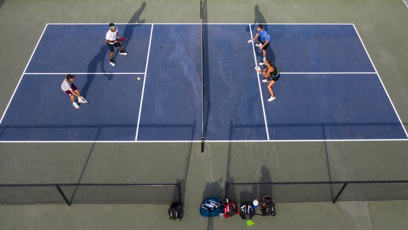 Spencer Smith, bottom left, and Chuck Taylor play pickleball with professional pickleball player Callie Smith, bottom right, and her husband, Kyle Smith, in Lehi on Tuesday, July 21, 2020.