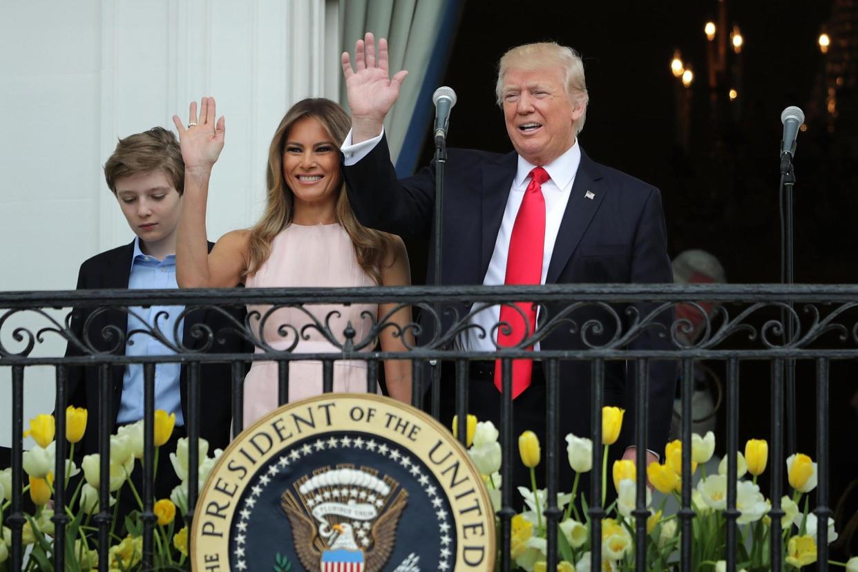 Picture: President Donald Trump and first lady Melania Trump wave to guests from the Truman Balcony with their son Barron Trump during the 139th Easter Egg Roll on the South Lawn of the White House April 17, 2017 in Washington, DC: (Chip Somodevilla/Getty Images)