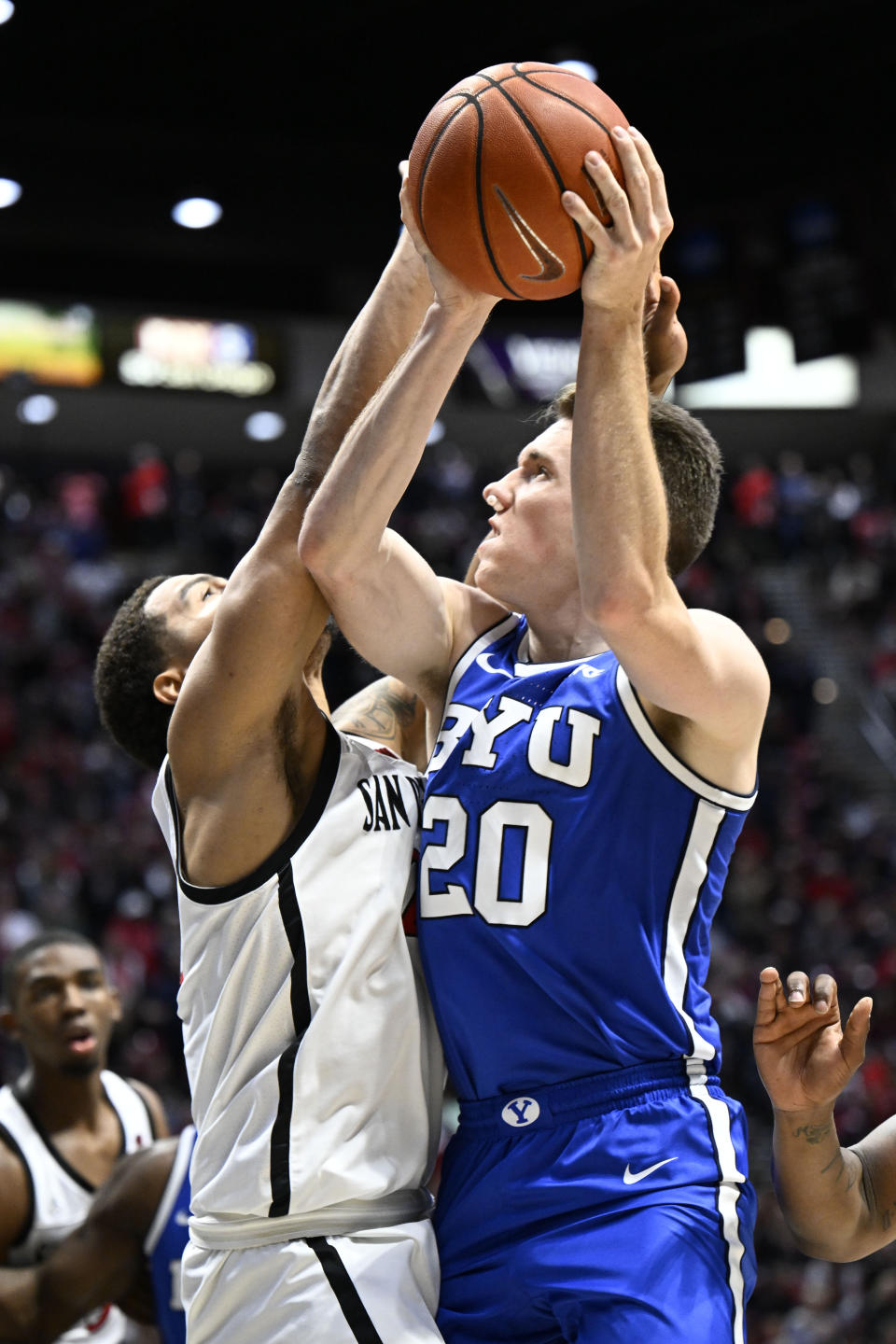 BYU guard Spencer Johnson (20) shoots over San Diego State guard Matt Bradley (20) during the second half of an NCAA college basketball game Friday, Nov. 11, 2022, in San Diego. (AP Photo/Denis Poroy)