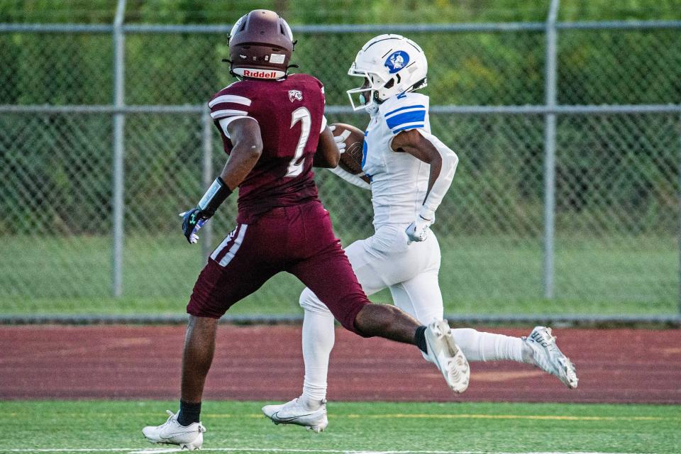 Dover receiver Jaheim Cole (right) bolts for a long gain as Appoquinimink sophomore Yalik Carter (2) gives chase on Thursday night. The Senators defeated the Jaguars 45-7 at Appoquinimink.