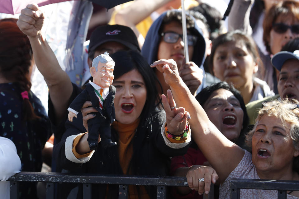 Celebrants get revved up as they gather in the Zocalo to see newly sworn-in President Andres Manuel Lopez Obrador, in Mexico City, Saturday, Dec. 1, 2018. Mexicans are getting more than just a new president Saturday. Lopez Obrador took the oath of office Saturday as Mexico's first leftist president in over 70 years, marking a turning point in one of the world's most radical experiments in opening markets and privatization. (AP Photo/Moises Castillo)