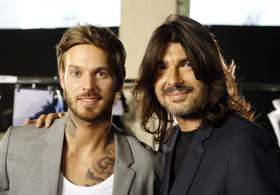 French fashion Stephane Rolland, right, poses with French rap artist M Pokora before his Haute Couture Fall-Winter 2013-2014 collection presented Tuesday, July 2, 2013 in Paris. (AP Photo/Francois Mori)