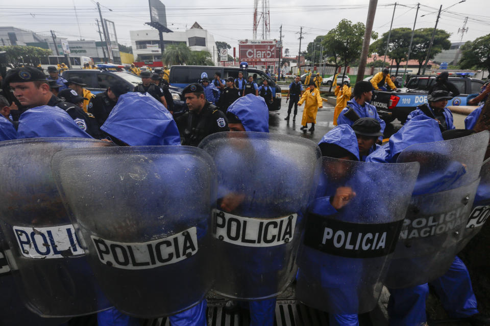 Nicaraguan police form a cordon to block demonstrators during an anti-government march dubbed, "Nothing is Normal” in honor of slain student Matt Romero, in Managua, Nicaragua, Saturday, Sept. 21, 2019. 16-year-old Matt Romero was killed during “crossfire” last September when armed men wearing hoods clashed with anti-government protesters. (AP Photo/Alfredo Zuniga)